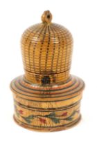 A whitewood paint decorated Tunbridge ware bee skep pin cushion, the circular box base lacking bun