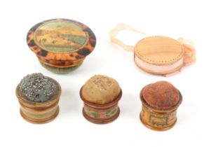 Five whitewood variously decorated Tunbridge ware pin cushions, comprising a burnt wood hanging