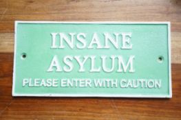 Cast iron insane asylum sign