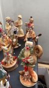 Porcelain clown figurines set, vibrant colors, humorously detailed.