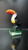 Guinness toucan advertising figurine, cast metal with vibrant hand-painted details.