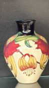 Moorcroft Anna Lily pottery vase with vibrant tube-lined floral design. Signed and stamped to base.
