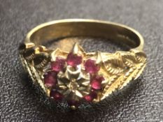 9ct Gold ring central diamonds surrounded by 8 rub