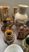 Collection of decorative vases and pitchers with intricate designs and vibrant colors, featuring