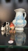 Hand-painted Shebeg porcelain cow by K.A. Mooney, Isle of Man, an artisan-glazed pottery jug, and