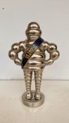 Michelin Bibendum figurine, cast metal with silver-tone finish. Features 