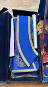 Masonic regalia set in original case includes ceremonial sashes, aprons, and medals with gold
