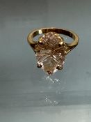 Large morganite ring set in yellow metal band, mor