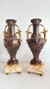 Pair of French patinated spelter urns on marble bases