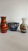 Three decorative vases, including Amphora cachepot