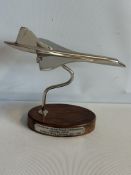 Chrome concorde on wooden base