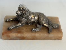 White metal dog lying down