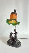 Figural spelter table lamp with ruffled glass shade