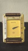 Gucci rectangular gold-plated quartz wristwatch, reference unknown, gilt dial with single black