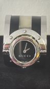 Gucci “Twirl” YA112 stainless-steel bangle wristwatch, black quartz dial, rotating bezel,