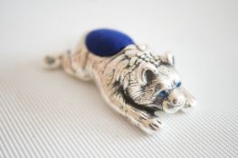 Silver lying down bear pin cushion with sapphire e