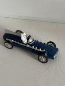 Cast iron Michelin Man in racing car