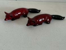 2 Royal Doulton flambe lying down foxes