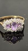 9ct Gold ring set with 3 amethyst surrounded by wh