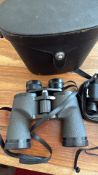 Group of three binoculars: full-size coated-optic model in leatherette hard case, compact folding