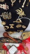 Mixed box of collectables to include brooches