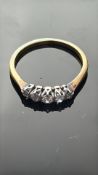 5 Stone diamond ring set in a yellow metal band We