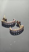 Pair of 9ct gold earrings set with purple stones W