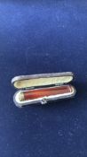 Cased cheroot holder with silver rim