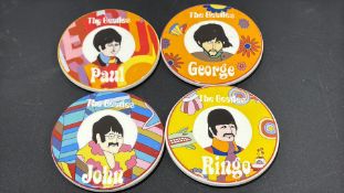 Set of four circular ceramic coasters printed with psychedelic Yellow Submarine-style portraits of