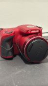 Red Canon PowerShot SX-series digital bridge camera with integrated high-zoom lens, supplied with
