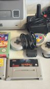 Nintendo SNES console with controllers and three games