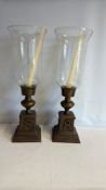 Pair of patinated brass hurricane candle holders
