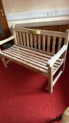Teak garden bench with brass plaque
