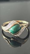 9ct Gold ring set with green stones surrounded by