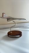 Chrome concorde on wooden base