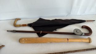 Group of five vintage walking canes, umbrella and wooden truncheon
