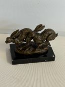Bronze running hares on marble base