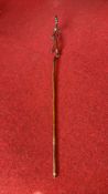 Carved rustic wood walking stick with anthropomorphic figure handle