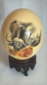 Hand-painted ostrich egg with wildlife and map decoration