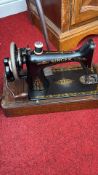 Singer hand-crank sewing machine with oak case
