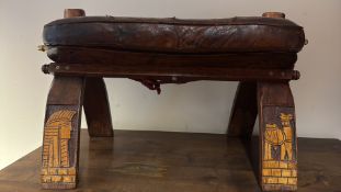 Egyptian-style carved camel saddle footstool with leather seat