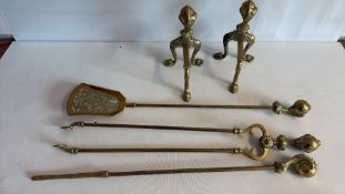 Group of brass andirons and fire irons