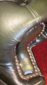 Pair of green leather Chesterfield-style wingback armchairs