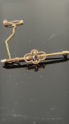 9ct Gold pin brooch with safety chain set with ame
