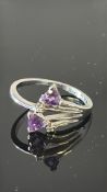 9ct White gold dress ring set with 2 purple stones