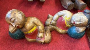 Pair of carved and painted reclining Asian child figures