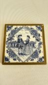 Brass framed delftware plaque