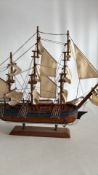 Wooden model of HMS Endeavour three-masted sailing ship with cloth sails, rigging and painted