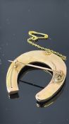 Yellow metal tested for gold horse shoe pin brooch