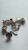 Silver charm bracelet 8 charms 56g